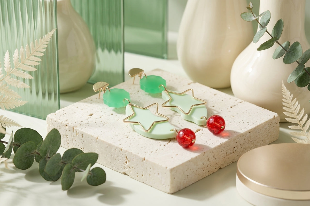 Green Sara long star dangle earrings in a styled product setting
