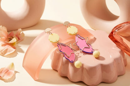 HB Sara long star dangle earrings in a styled product setting