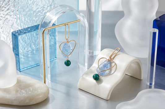 Blue Sofia heart teardrop dangle earrings in a styled product setting
