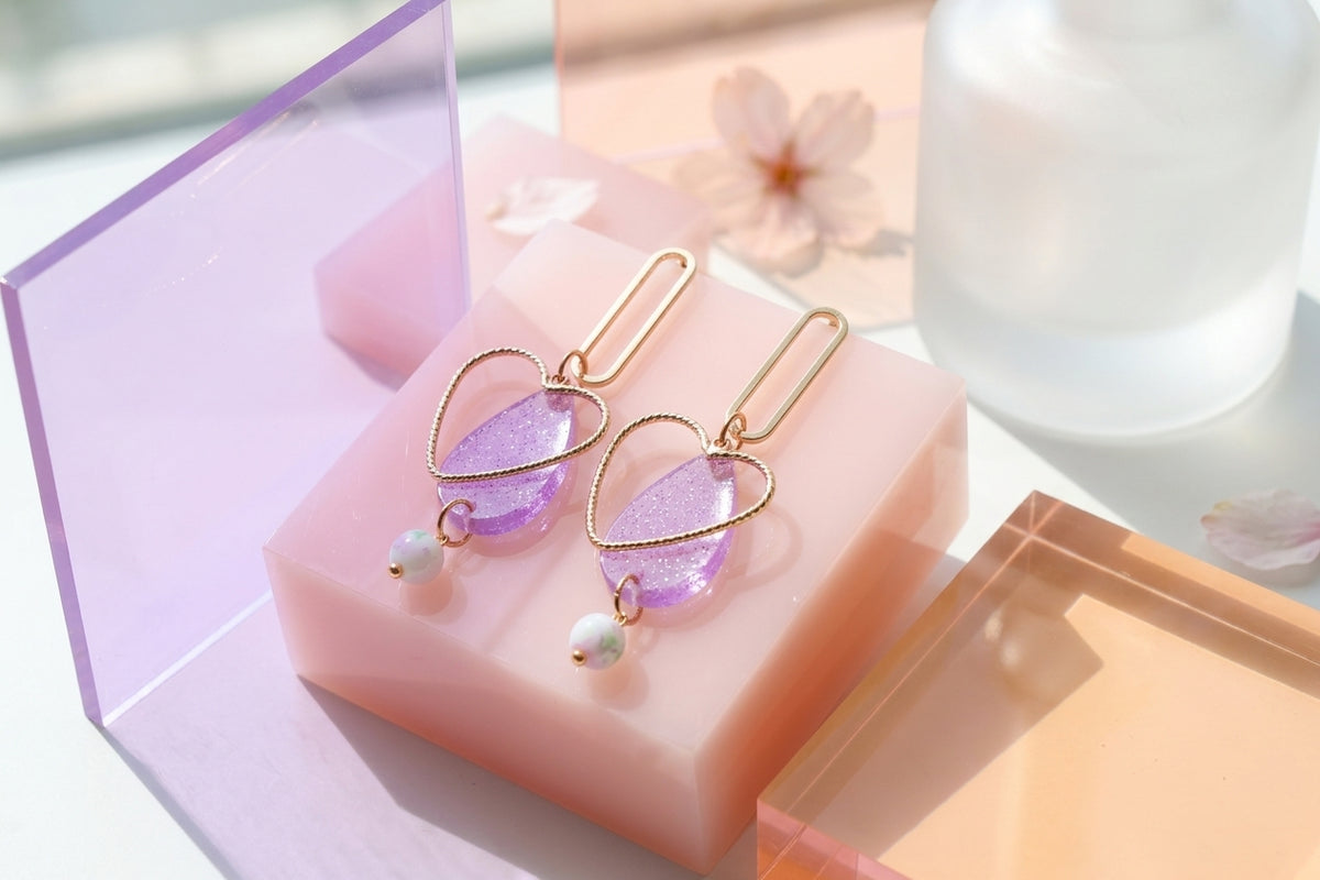 Purple Sofia heart teardrop dangle earrings in a styled product setting