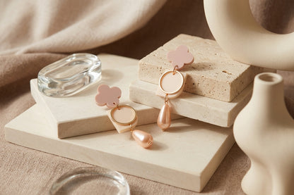 Beige Zoe floral geometric drop earrings in a styled product setting