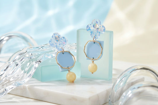 Blue Zoe floral geometric drop earrings in a styled product setting