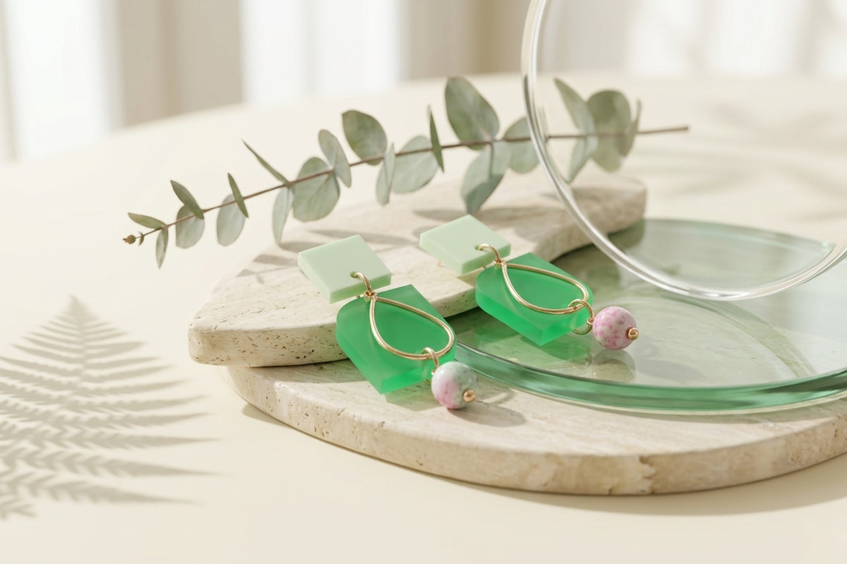 Green Zoe floral geometric drop earrings in a styled product setting