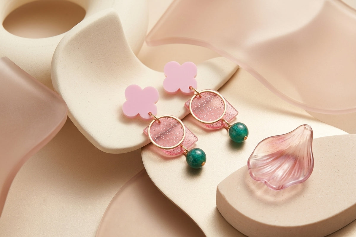 Pink Zoe floral geometric drop earrings in a styled product setting