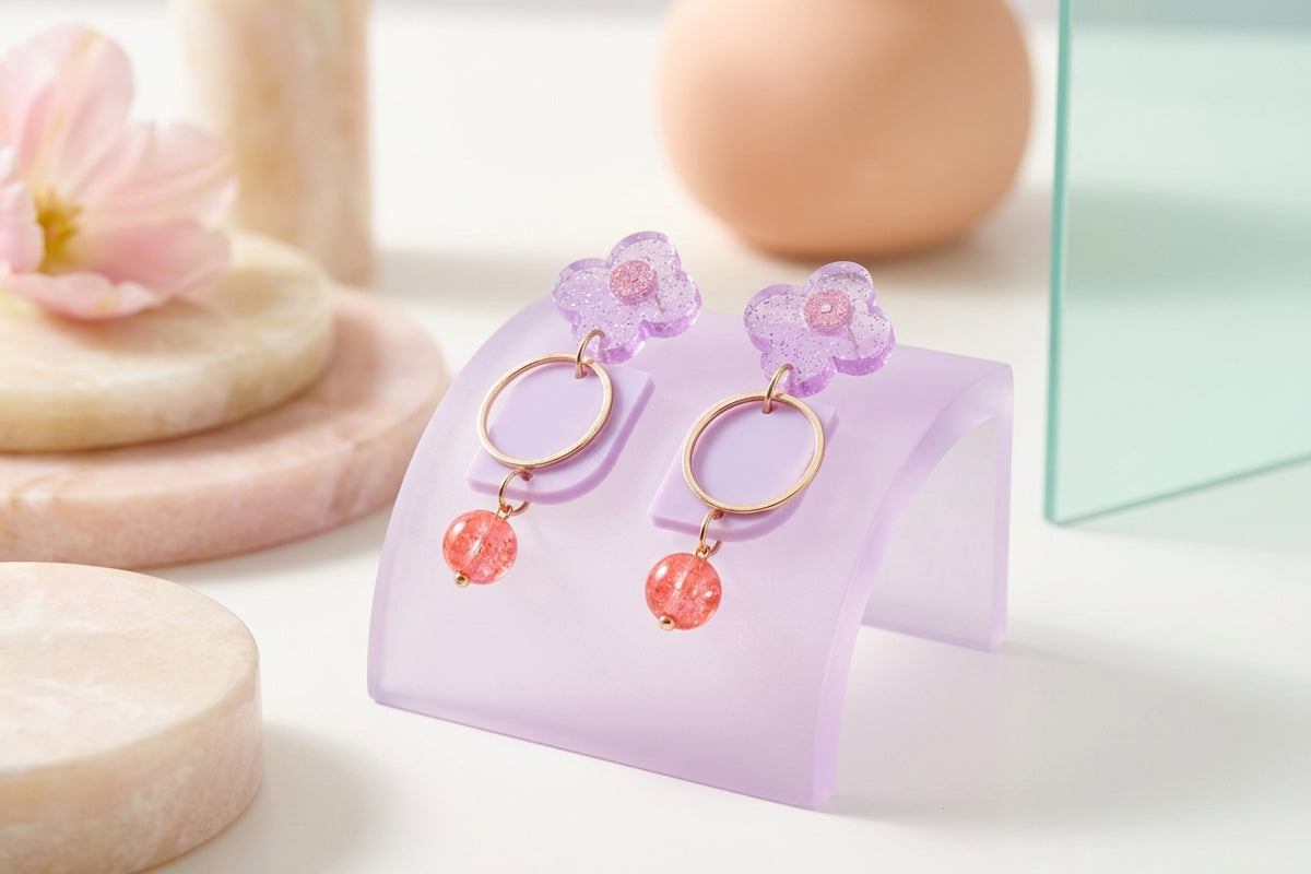 Purple Zoe floral geometric drop earrings in a styled product setting